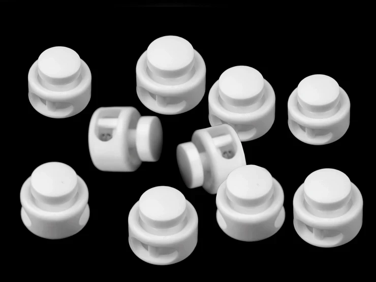 stopery plastikowe z dwiema dziurkami do sznurka okragłe.jpg